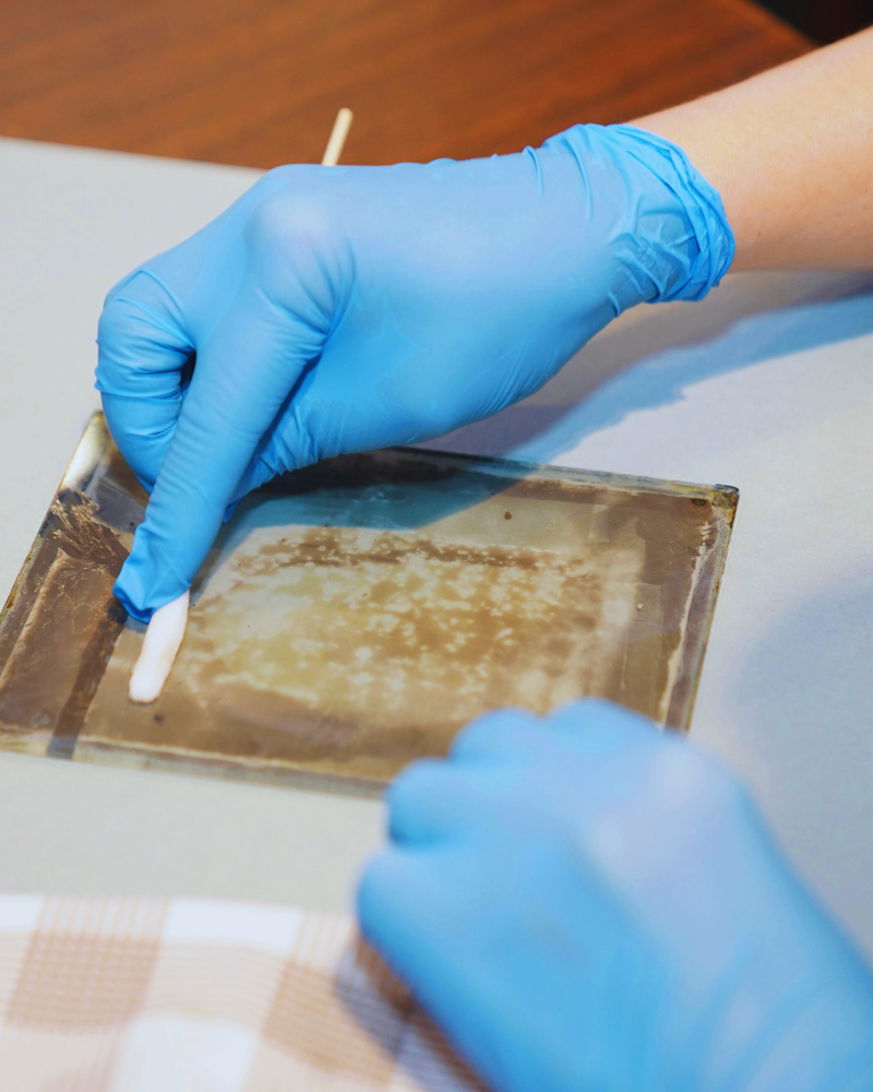 Person gently cleaning an artifact